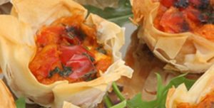 Mini quiche with filo pastry on a tray as snack for a drinks party