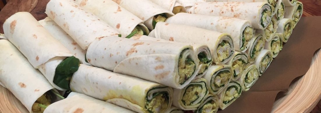 Tray with chicken curry cranberry wraps
