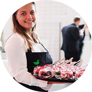 Friendly catering staff with tray of appetizers